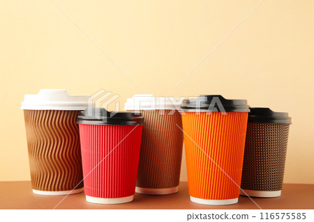 Many different cups of coffee on beige background. Top view 116575585