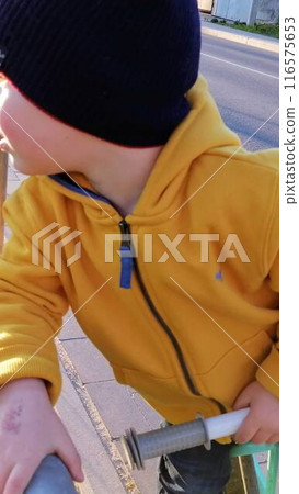 Adorable toddler boy having fun on playground 116575653