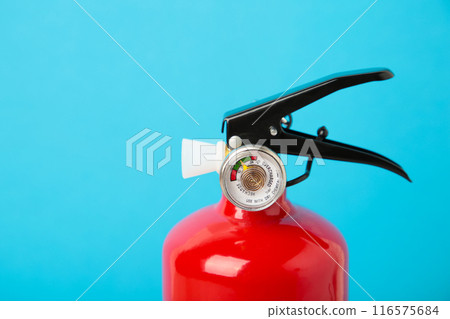 Red foam fire extinguisher on blue background. 116575684