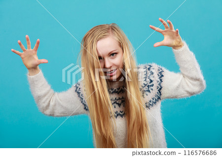 Young blonde woman making scary faces Young blonde woman making scary faces 116576686