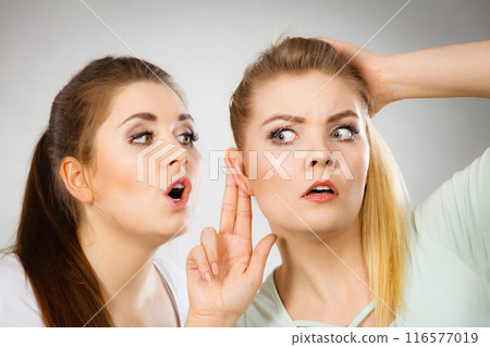 Two women telling gossip 116577019
