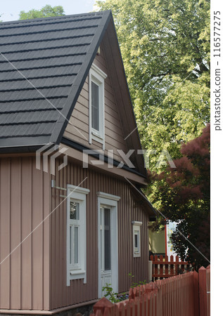 View of a part of the wall of an old wooden house . High quality photo 116577275