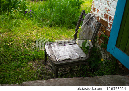 An old chair in an abandoned house 116577624