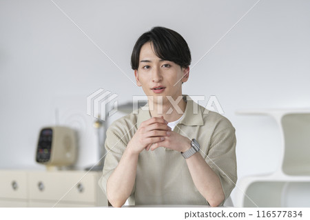 A man in his 20s looking at the camera A man in his 20s looking at the camera 116577834