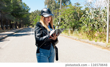 Woman Taking Notes Under The Sun  116578648
