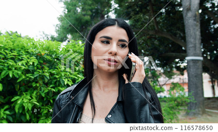 Woman Having A Talk At The Phone In The Park  116578650