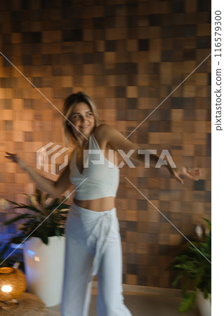 Girl doing meditating bodywork at the gym . Girl doing yoga in the gym 116579300