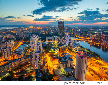 Yekaterinburg city and pond aerial panoramic view at summer or early autumn night. Night city in the early autumn or summer. Yekaterinburg city and pond aerial panoramic view at summer or early autumn night. Night city in the early autumn or summer. 116579733