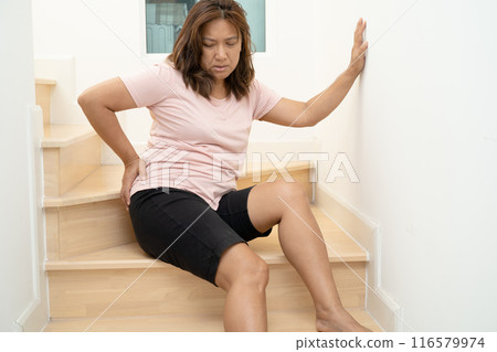 Asian lady fall down the stairs and pain at hip and waist because slippery surfaces. Asian lady fall down the stairs and pain at hip and waist because slippery surfaces. 116579974