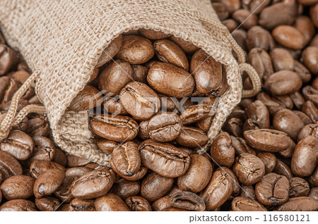 Natural roasted coffee beans in a bag as a background. Natural roasted coffee beans in a bag as a background. 116580121