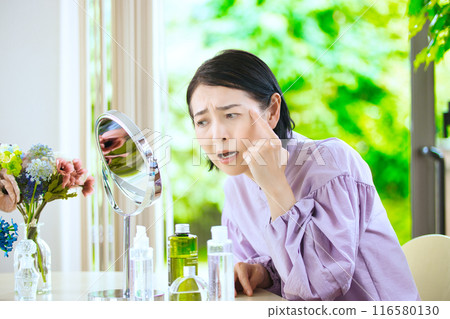 Middle woman worried about fine wrinkles Middle woman worried about fine wrinkles 116580130