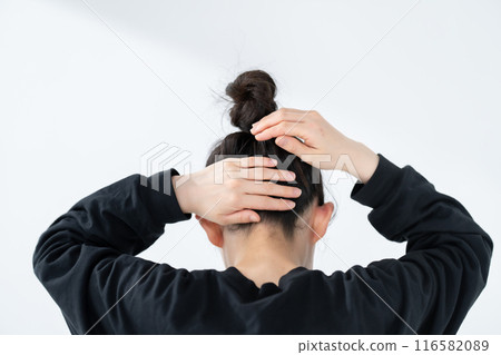 Woman with bun hair, back view Woman with bun hair, back view 116582089
