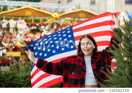 Woman waving USA flag at street new year fair 116582559