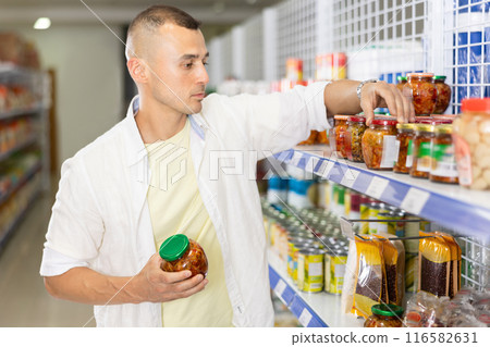 Man shopping at grocery store - choosing tasty Chinese mustard 116582631