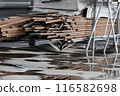 A pile of metal pipes is on the ground. The pile is large and has a lot of pieces. The image has a 116582698
