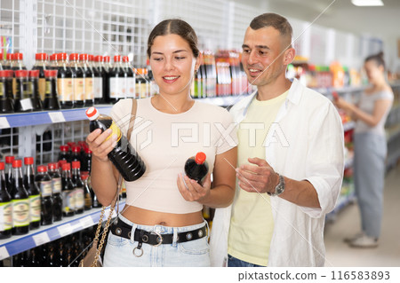 Couple man and woman choosing soy sauce 116583893