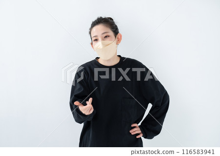 A woman with a bun hairstyle wearing a mask 116583941