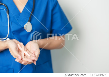 Doctor holding Peach Ribbon for September Uterine Cancer Awareness month. Uterus and Ovaries, Endometriosis, Hysterectomy, Uterine fibroids, Reproductive, Healthcare and World cancer day concept 116584923