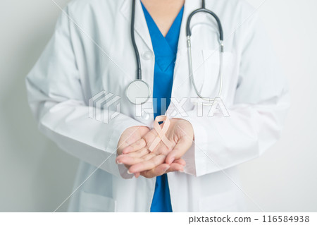 Doctor holding Peach Ribbon for September Uterine Cancer Awareness month. Uterus and Ovaries, Endometriosis, Hysterectomy, Uterine fibroids, Reproductive, Healthcare and World cancer day concept 116584938