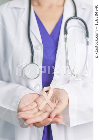 Doctor holding Peach Ribbon for September Uterine Cancer Awareness month. Uterus and Ovaries, Endometriosis, Hysterectomy, Uterine fibroids, Reproductive, Healthcare and World cancer day concept Doctor holding Peach Ribbon for September Uterine Cancer Awareness month. Uterus and Ovaries, Endometriosis, Hysterectomy, Uterine fibroids, Reproductive, Healthcare and World cancer day concept 116584940
