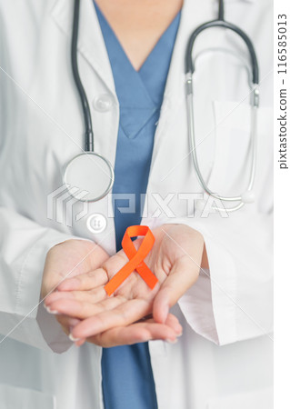Doctor with Orange Ribbon for Leukemia, Kidney cancer day, world Multiple Sclerosis, CRPS, Self Injury Awareness month. Healthcare and word cancer day concept 116585013