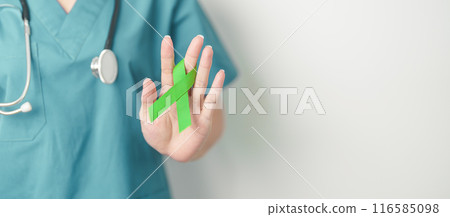 Doctor with green Ribbon for world Lymphoma Awareness September month, world Mental Health Day, Liver, Gallbladders, bile duct, cervical, kidney Cancer. Healthcare and world cancer day concept 116585098