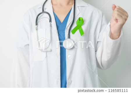 Doctor with green Ribbon for world Lymphoma Awareness September month, world Mental Health Day, Liver, Gallbladders, bile duct, cervical, kidney Cancer. Healthcare and world cancer day concept 116585111