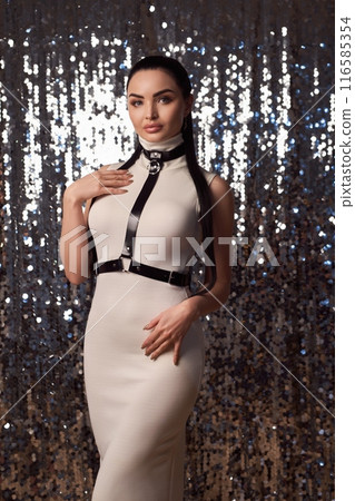Seductive woman in dress and harness on New Year's party 116585354