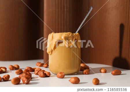Peanut paste in a glass jar, on a dark background. 116585536