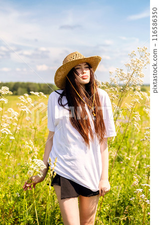 Dreamy woman with sunhat in nature. Dreamy woman with sunhat in nature. 116586350