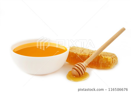 Fresh honey in bowl with honeycomb isolated on white background. Fresh honey in bowl with honeycomb isolated on white background. 116586676