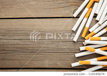 Cigarettes on grey wooden background. Top view. Cigarettes on grey wooden background. Top view. 116586679