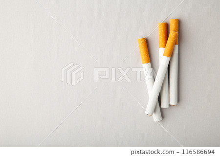 Cigarettes on grey background with copy space. Cigarettes on grey background with copy space. 116586694