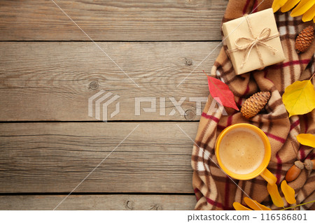 Hot coffee and autumn leaves on grey wooden background - seasonal relax concept Hot coffee and autumn leaves on grey wooden background - seasonal relax concept 116586801