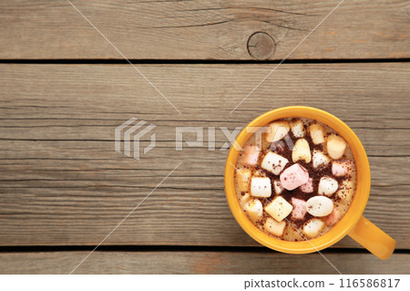 Cocoa in yellow mug with marshmallows on grey background. 116586817