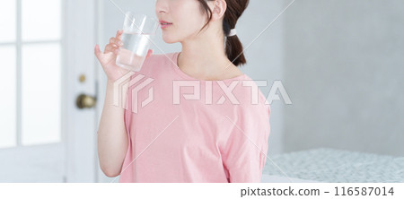 Young woman drinking water Young woman drinking water 116587014