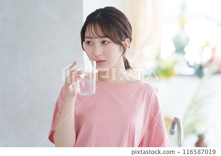 Young woman drinking water 116587019