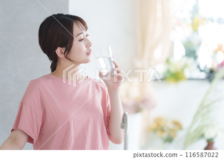 Young woman drinking water 116587022