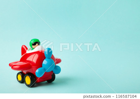 Plastic toy plane on blue background. Airplane Plastic toy plane on blue background. Airplane 116587104