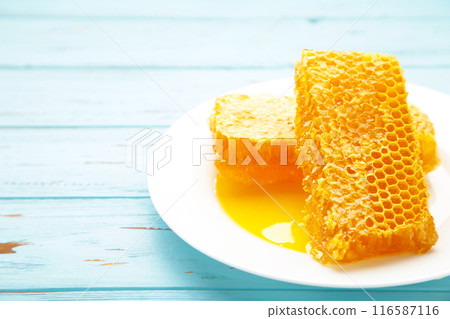 Sweet honeycomb on blue background. Top view 116587116