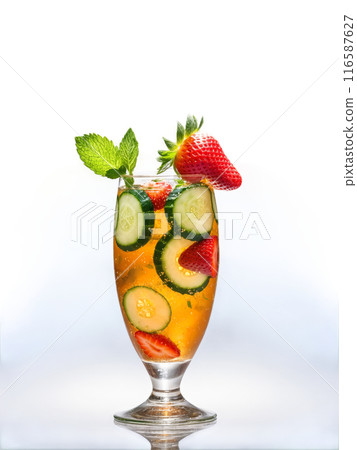 British Pimm s Cup in clear glass filled with cucumber slices strawberries and mint leaves 116587627
