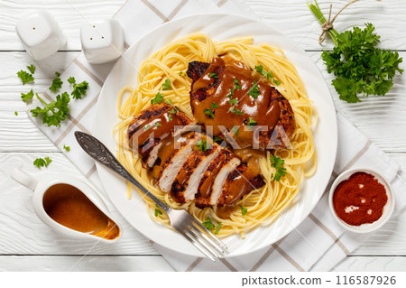 Chicken Lazone with sauce and linguine on plate Chicken Lazone with sauce and linguine on plate 116587926