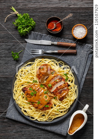 Chicken Lazone with sauce and linguine on plate Chicken Lazone with sauce and linguine on plate 116587929
