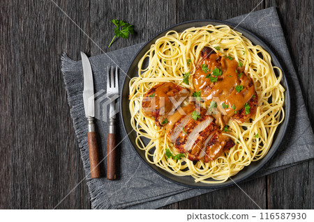 Chicken Lazone with sauce and linguine on plate 116587930