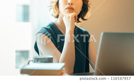 Japanese woman thinking while using a computer 116587957