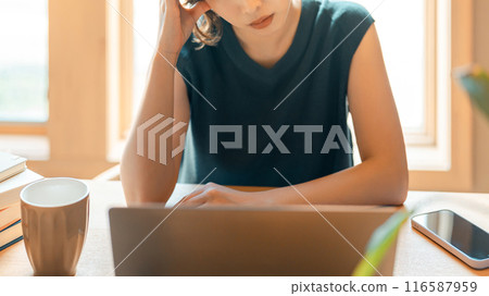A Japanese woman worried while using a computer A Japanese woman worried while using a computer 116587959