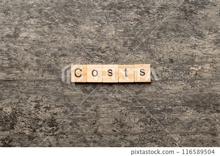costs word written on wood block. costs text on cement table for your desing, concept 116589504