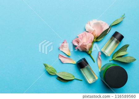 Composition with cosmetic products and beautiful roses on color background. Copy space, flat lay Composition with cosmetic products and beautiful roses on color background. Copy space, flat lay 116589560