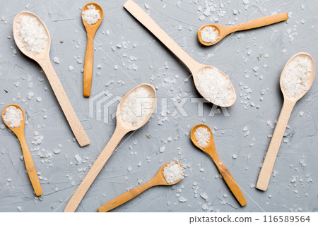 salt on many wooden spoon on wood background. Spoons with different salt salt on many wooden spoon on wood background. Spoons with different salt 116589564