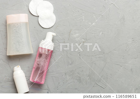 Micellar cleansing water and discs to remove cosmetics and cleanse the skin on colored background. Copy space top view 116589651